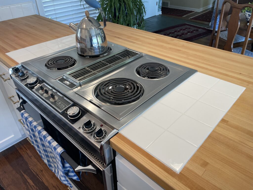 Tile trivet on both sides of range, inset into wood butcher block countertop by Action Craftworks LLC in Vancouver WA