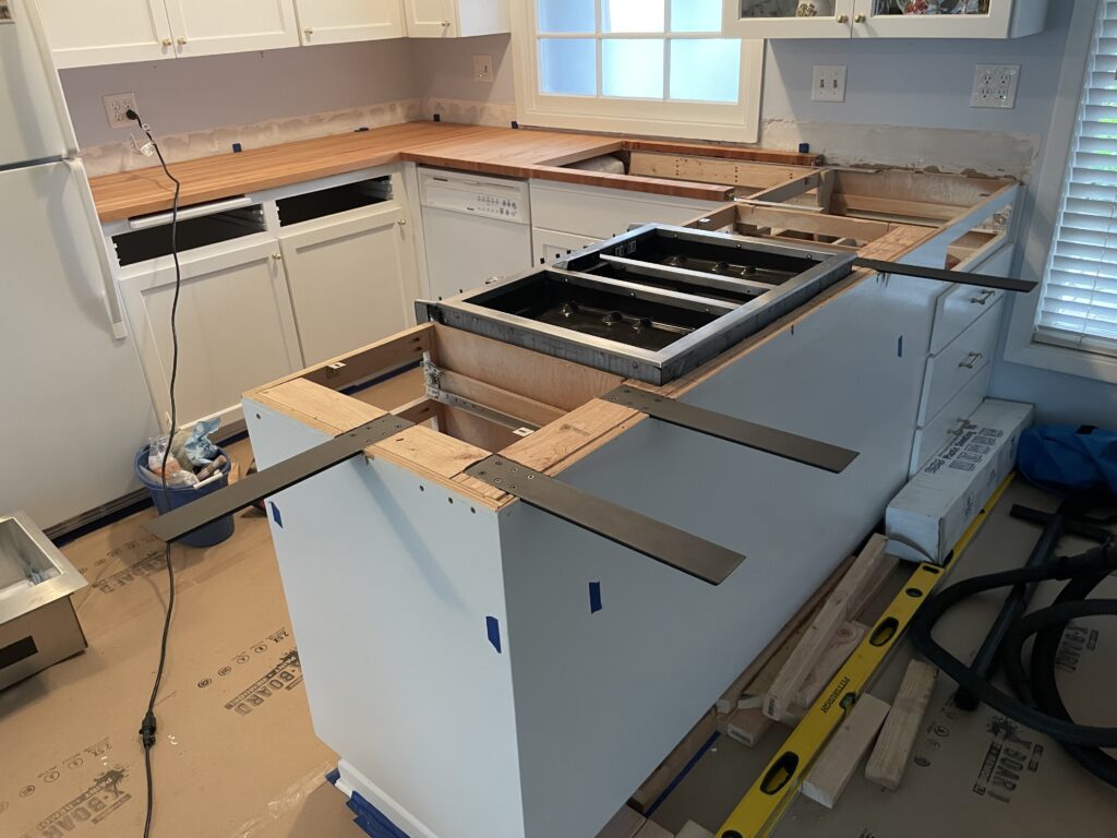 Heavy duty steel countertop supports attached to 2x4 blocking added to top of base cabinets