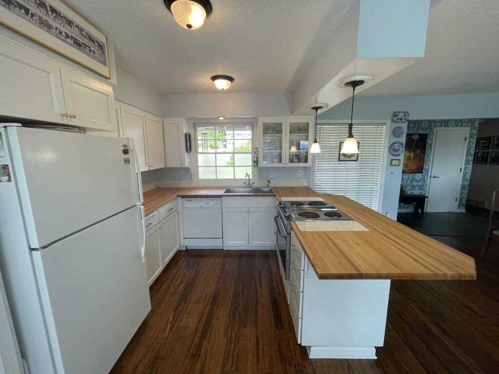 Kitchen renovation with butcher block countertops end view by Action Craftworks LLC in Vancouver WA
