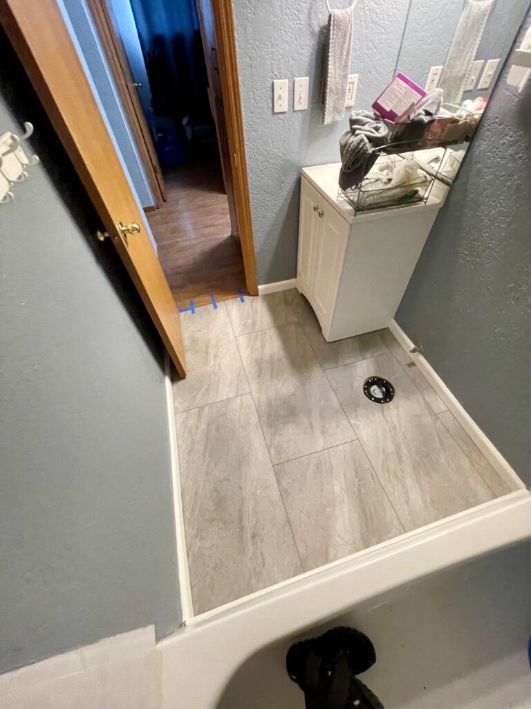Bathroom remodel with new flooring and PVC wall base by Action Craftworks in Vancouver, WA