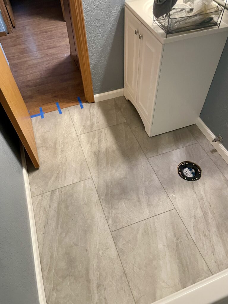 Bathroom renovation with large format LVT flooring by Action Craftworks LLC in Vancouver, WA