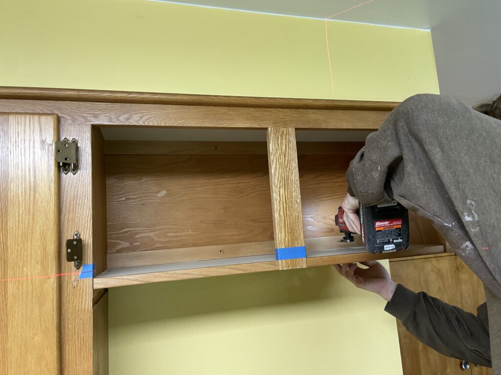 Cutting the kitchen cabinet above new refrigerator by Action Craftworks LLC in Vancouver, WA
