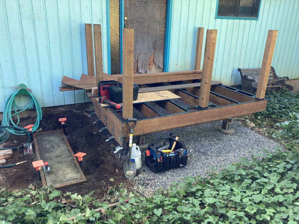 Concrete base pad for steps stringers for porch deck rebuild by Action Craftworks LLC in Vancouver, WA