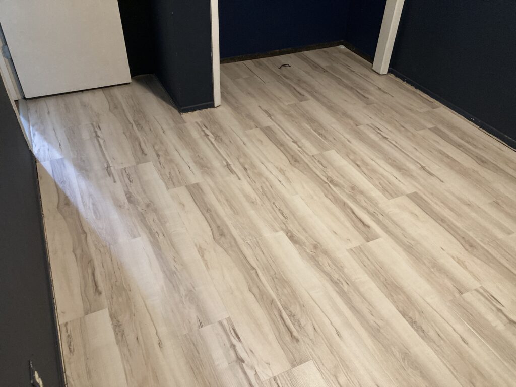 Luxury vinyl-plank flooring in bedroom by Action Craftworks LLC in Vancouver, WA