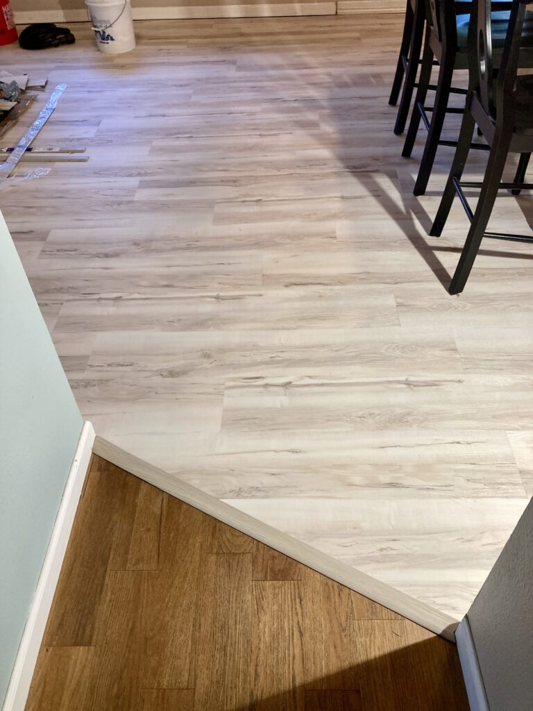 LVP transition in whole home flooring renovation by Action Craftworks LLC in Vancouver, WA