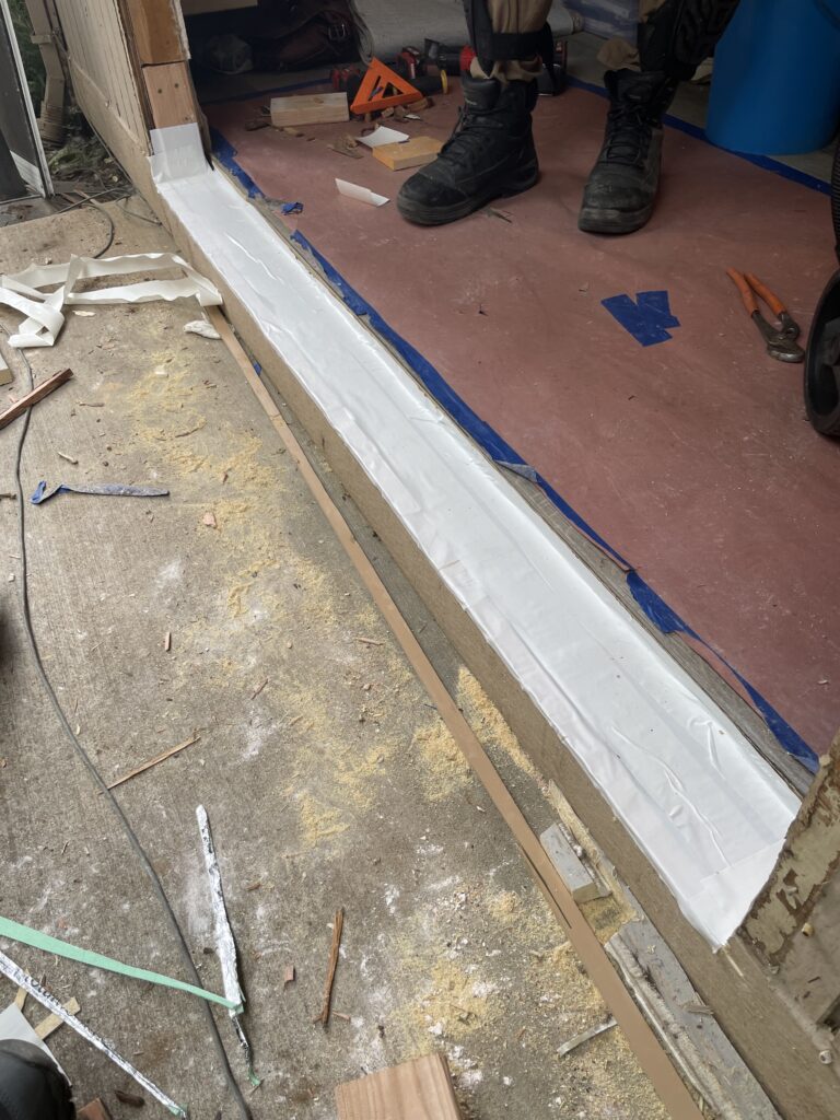 Waterproof sill plate installed for under new French doors by Action Craftworks in Vancouver, WA